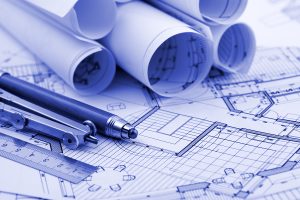 rolls of blueprints & work tools - ruler, pencil, compass