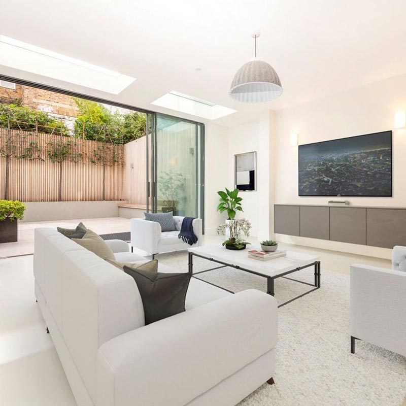 2 rooflights in clean white living room with large sliding doors