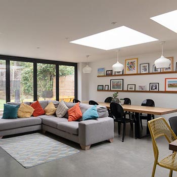 fixed rooflight with l sofa living room | EOS Rooflights fixed rooflight in open living room with grey sofa