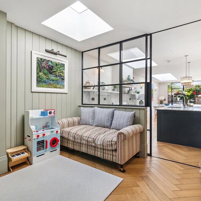 Small electric  opening rooflight in trendy kitchen with green panel wall