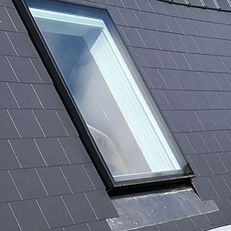 Pitched slate tiled roof with seamless skylight