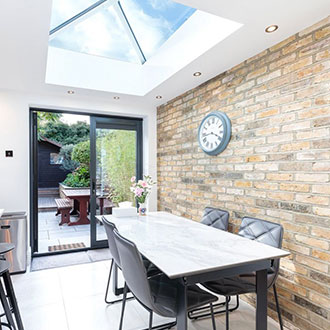 lantern rooflight in dining room with brick wall | EOS Rooflights lantern rooflight in dinning room with large brick wall
