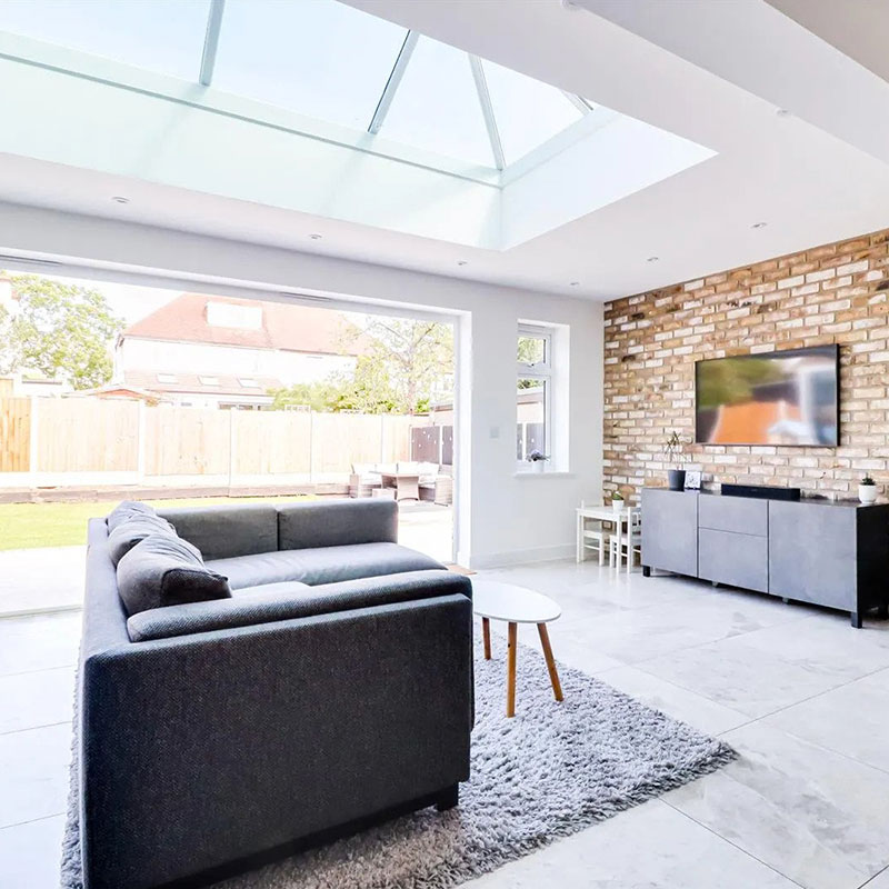 Lantern rooflight in bright airy living room in white.